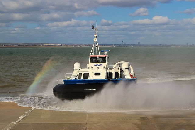 Hovercraft arriving on the beach at Ryde with a rainbow in its spray