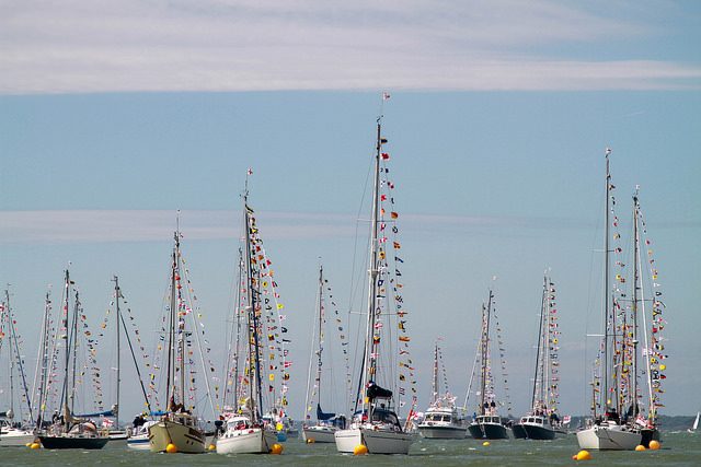 Fleet of yachts dressed overall with signal flags