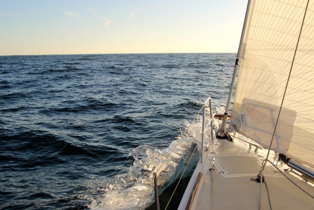 Bow wave of a yacht at sea in the evening